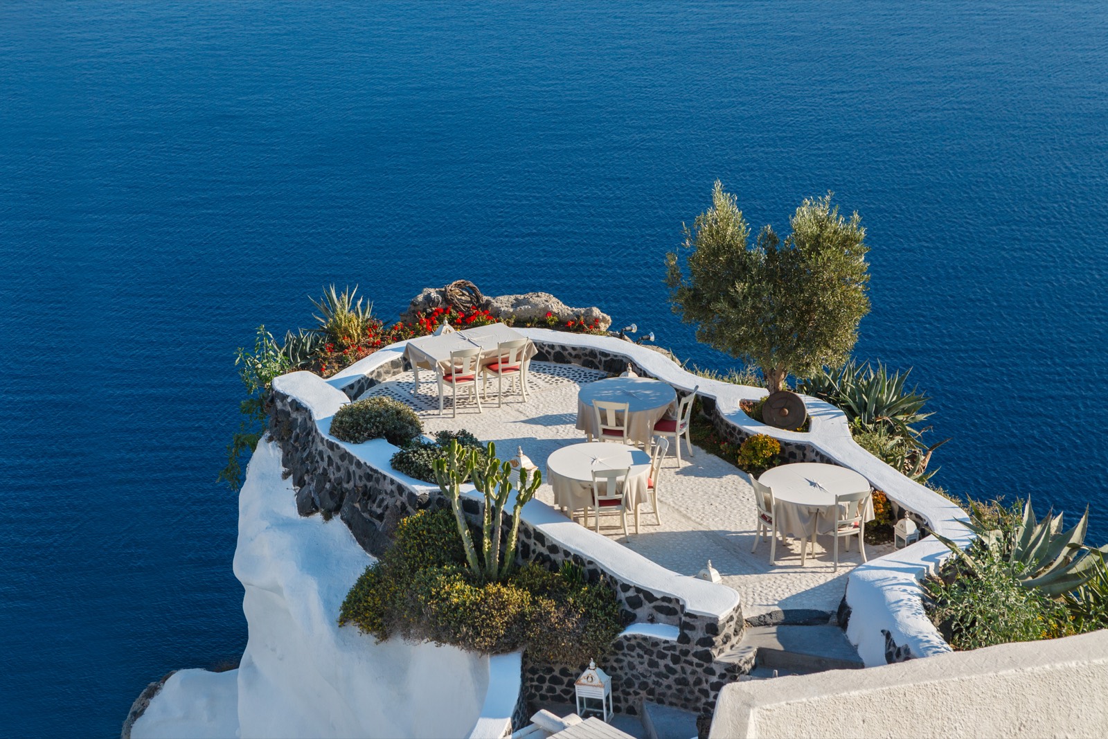Empty tables in a restaurant overlooking the sea
